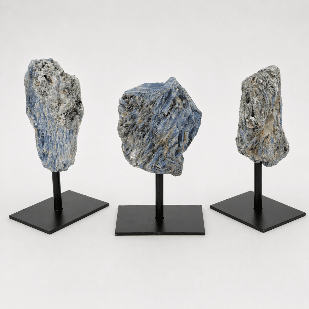 Rough blue kyanite specimen on a metal stand
