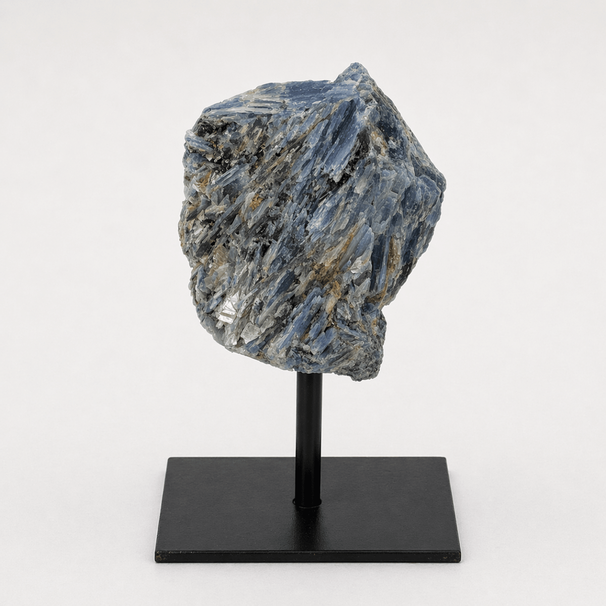Rough blue kyanite specimen on a metal stand, view 2
